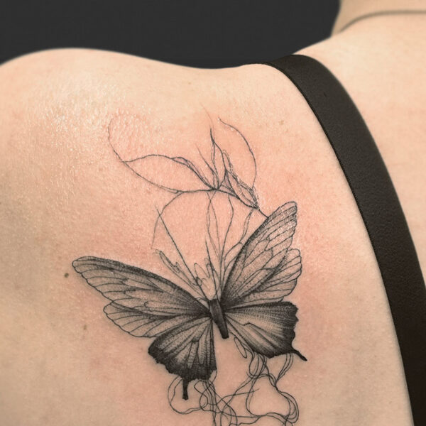 Atticus Tattoo| Black and grey tattoo of a butterfly with abstract veins behind it