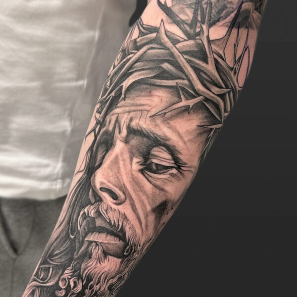 Atticus Tattoo| Black and grey, realism tattoo of Jesus