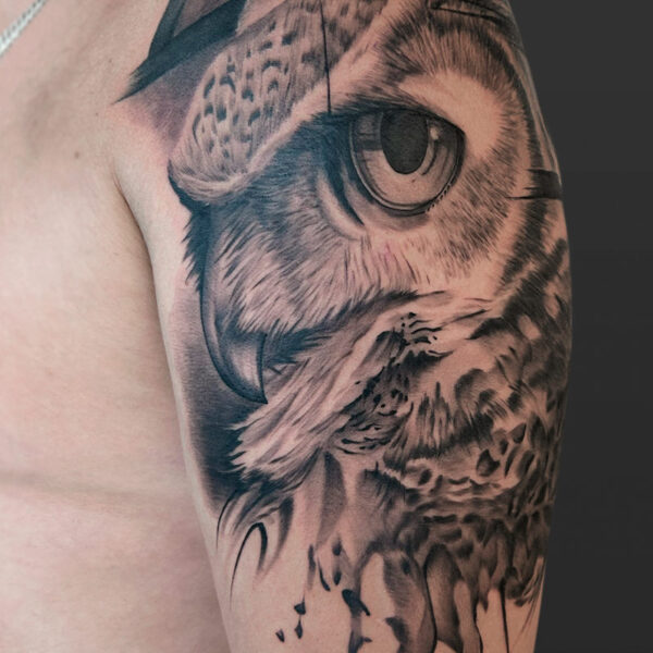 Atticus Tattoo| Black and grey, realism tattoo of an owl's face with abstract elements around it