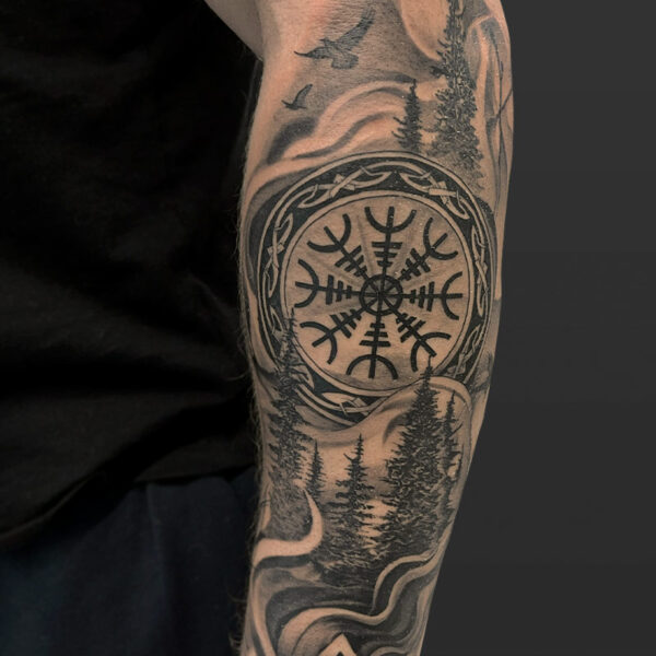 Atticus Tattoo| Black and grey tattoo of Nordic runes with a forest background