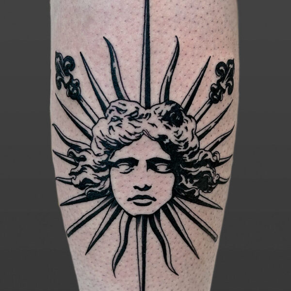 Atticus Tattoo| Blackwork tattoo of a woman's face with spikes coming out of her head, like a sun