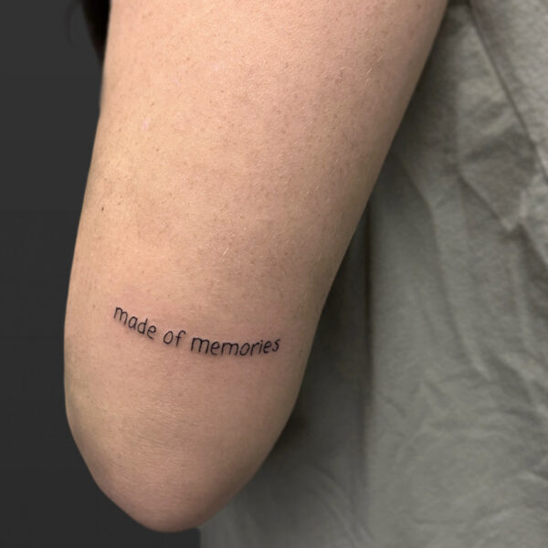 Atticus Tattoo| Fine line, script tattoo of the words "Made of Memories"