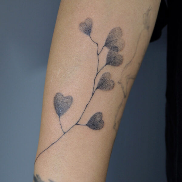 Atticus Tattoo| Fine line tattoo of a stem of leaves that are heart shaped