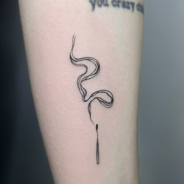 Atticus Tattoo| Fine line tattoo of a match with smoke lines