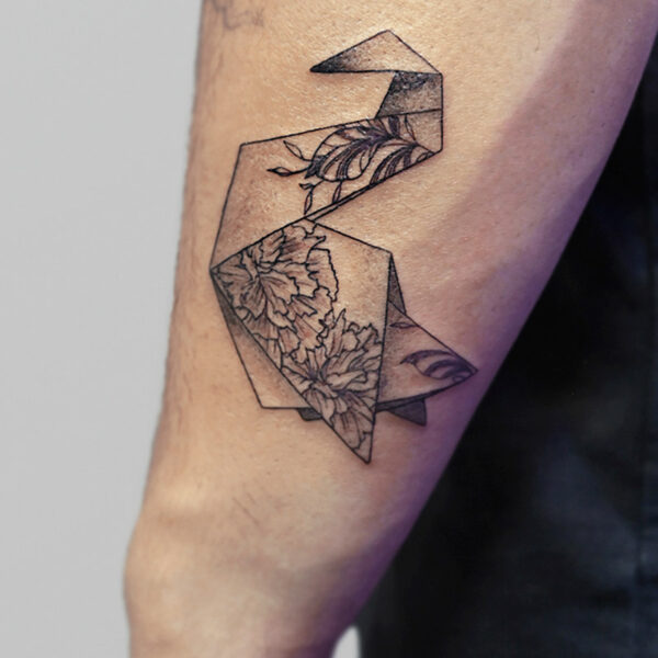 Atticus Tattoo| Fine line tattoo of an origami swan with flowers