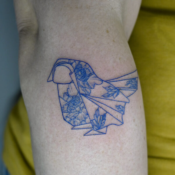 Atticus Tattoo| Fine line tattoo of an origami bird done with blue ink