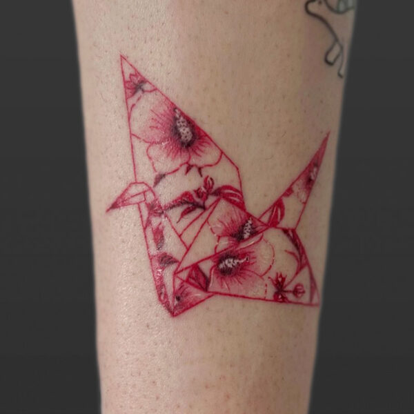 Atticus Tattoo| Fine line tattoo of a red origami, crane with flowers