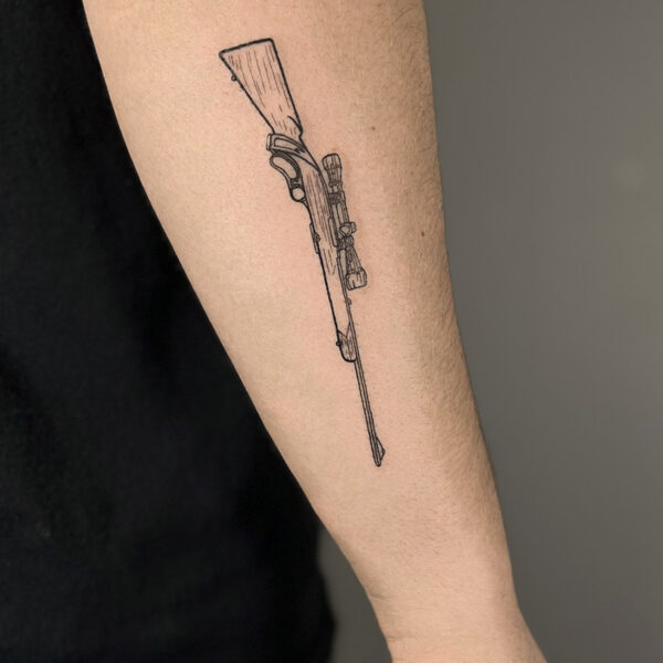 Atticus Tattoo| Fine line tattoo of a hunting rifle