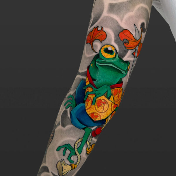 Atticus Tattoo| Neotraditional tattoo of a green frog, wearing an orange, red and blue yukata