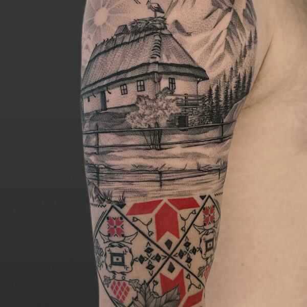 Atticus Tattoo| Black and grey tattoo of a mountain, cabin, cranes and red and black, Ukrainian pattern