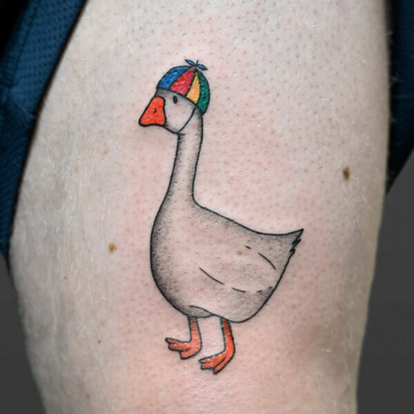 Atticus Tattoo| Tattoo of a goose wearing a propeller beanie