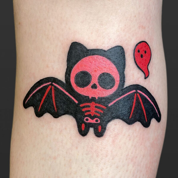 Atticus Tattoo| Royal Tattoo| Blackwork tattoo of a cartoon bat with a pink and red skeleton and a small red ghost