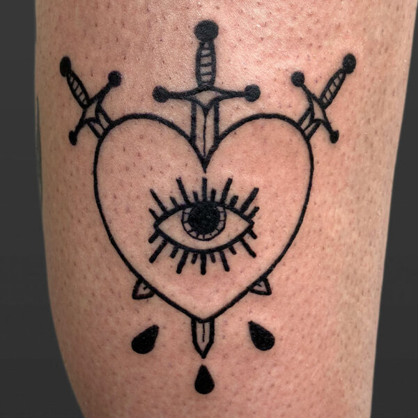 Atticus Tattoo| American traditional tattoo of a heart with three swords going through it and an eye in the centre