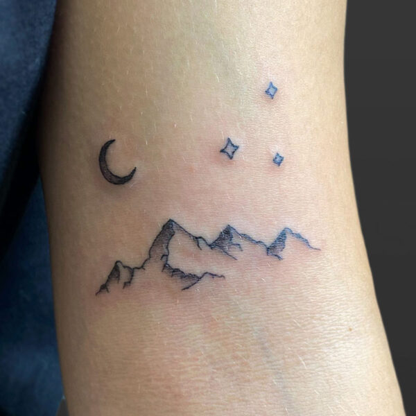 Atticus Tattoo| Fine line tattoo of a mountain range with a crescent moon and stars