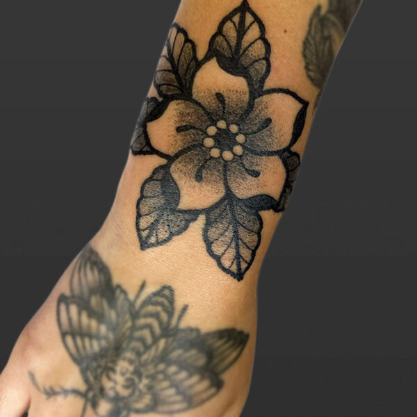 Atticus Tattoo| Neotraditional tattoo of a black and grey flower