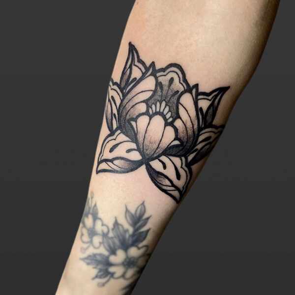 Atticus Tattoo| Neotraditional tattoo of a black and grey lotus