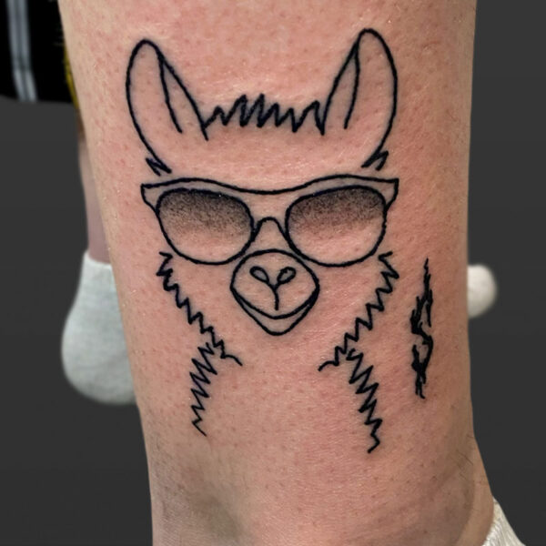 Atticus Tattoo| Line tattoo of a lama wearing sunglasses