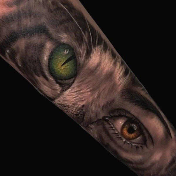 Atticus Tattoo| Colour realism tattoo of a cat eye and woman's eye, combined