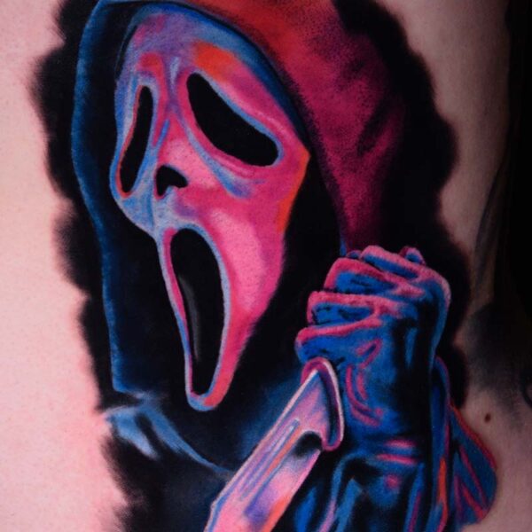 Atticus Tattoo| Colour realism tattoo of Ghostface holding a knife, with pink and blue inks