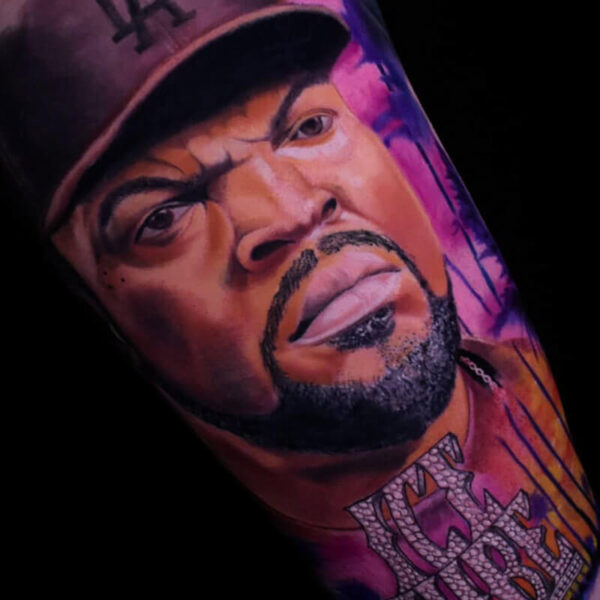 Atticus Tattoo| Colour realism tattoo of Ice Cube with pink sunset background