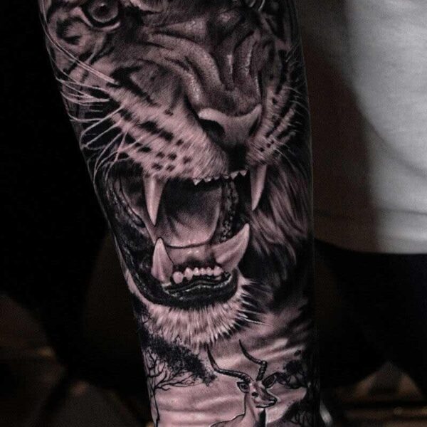 Atticus Tattoo| Black and grey realism tattoo of a leopard and savannah with gazelle
