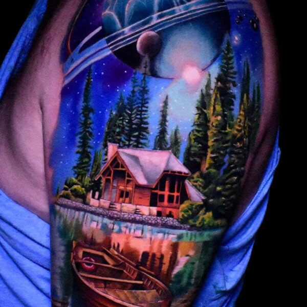 Atticus Tattoo| Colour realism tattoo of a cabin in the woods, lake, canoe and planet above