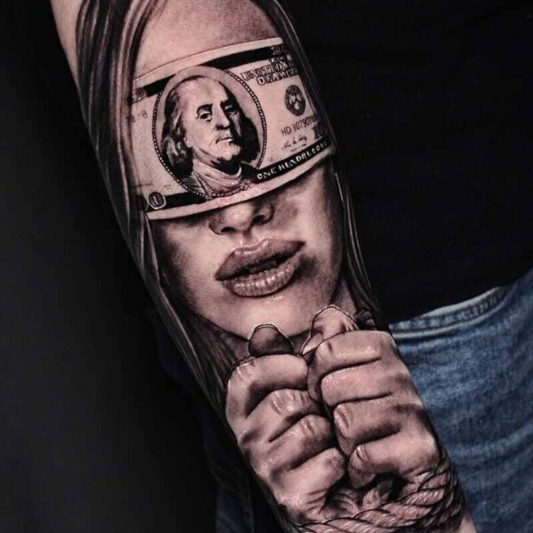 Atticus Tattoo| Black and grey realism tattoo of a woman that is tied up and a $100 as a blindfold