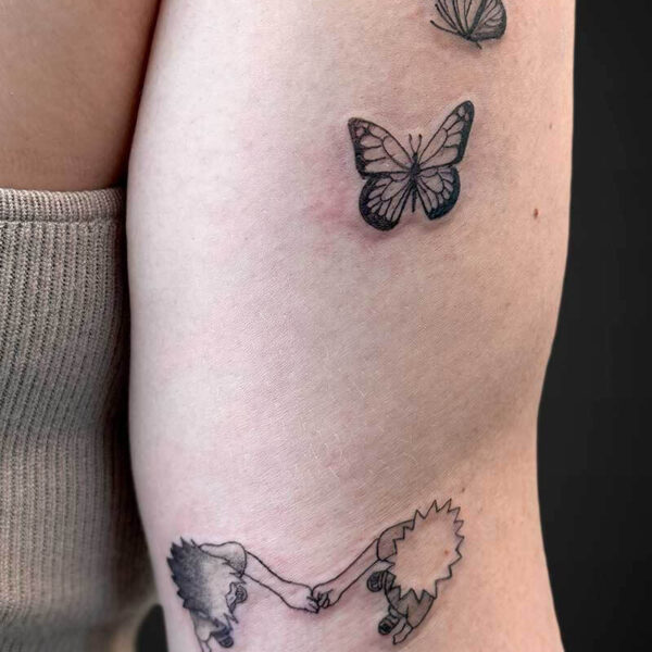 Atticus Tattoo| Anime tattoo of Naruto and Sasuke and two butterflies