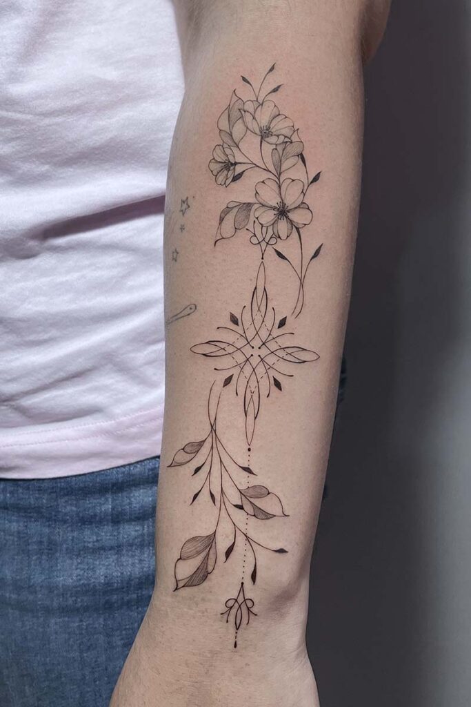 Atticus Tattoo| Fineline tattoo of an ornamental design and florals
