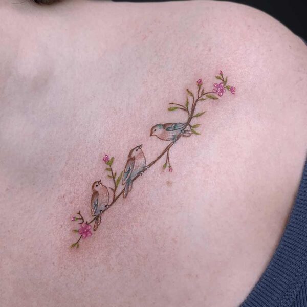 Atticus Tattoo| Walk-in Tattoo| Microrealism tattoo of three small birds sitting on a branch with pink flowers