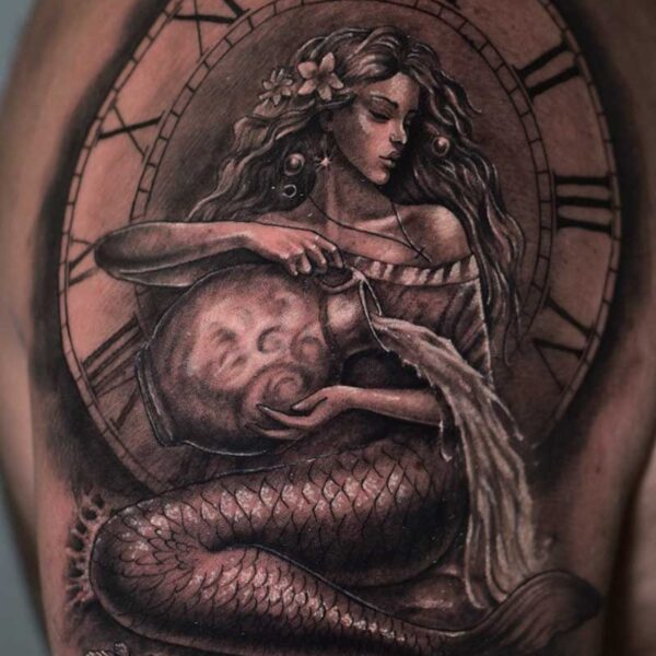 Atticus Tattoo| Realism tattoo of a mermaid pouring water out of a vase and a clock behind her