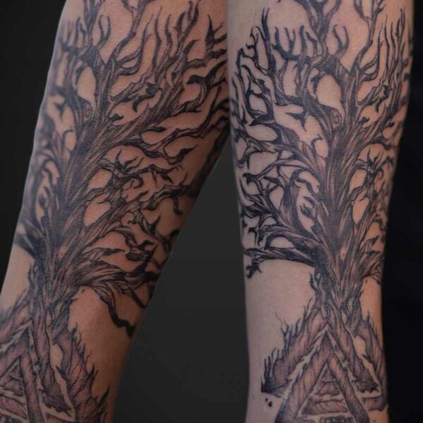 Atticus Tattoo| Illustrative Tattoo| Black and grey, illustrative tattoo of a dead, twisted tree with a Viking triangle