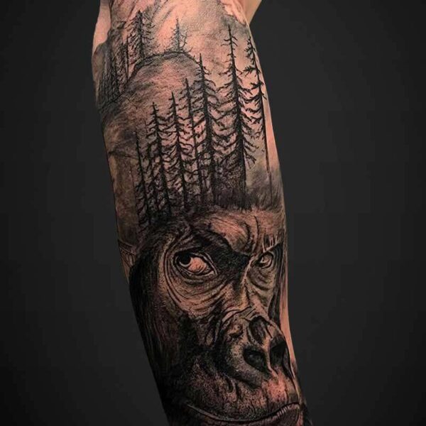Black and Grey Realism Tattoo- Gorilla and Mountains Atticus Tattoo| Black and grey realism tattoo of a gorilla and mountain scene