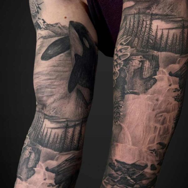 Black and Grey Realism Tattoo- Waterfall and Orca Atticus Tattoo| Black and grey realism tattoo of a waterfall scene and an orca jumping out of the ocean scene