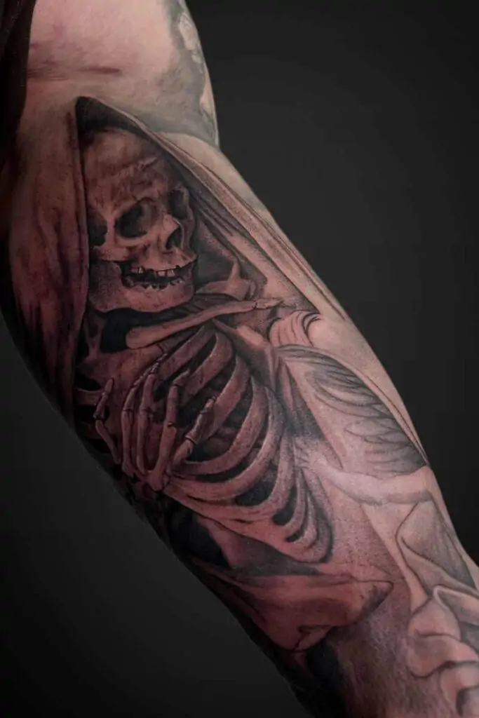 Atticus Tattoo| Black and grey realism tattoo of a skeleton in a cloak