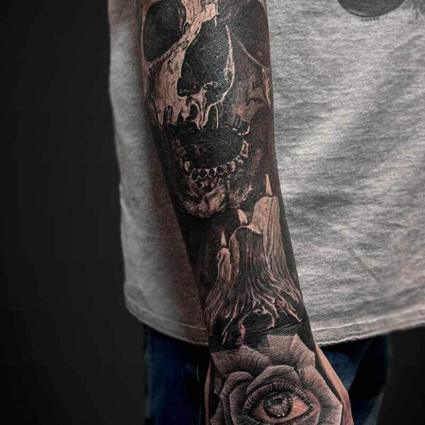Black and Grey Realism Tattoo- Skull and Candles Atticus Tattoo| Black and grey realism tattoo of a skull, burning candles and a rose with an eye in the center