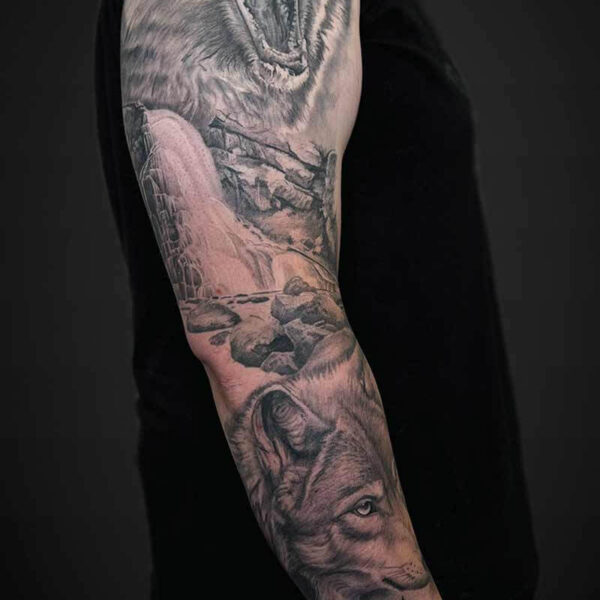 Black and Grey Realism Tattoo- Bear and Wolf Atticus Tattoo| Black and grey realism tattoo of a bear, waterfall scene and wolf