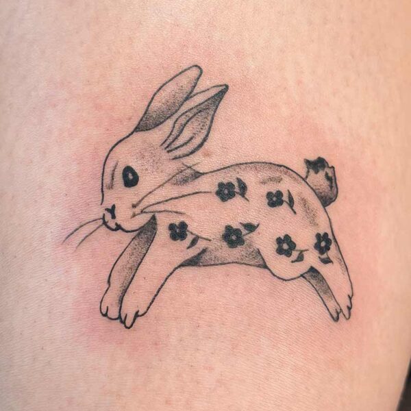 Black and Grey Tattoo- Bunny and Flowers Atticus Tattoo| Black and grey tattoo of a bunny with a black flower pattern