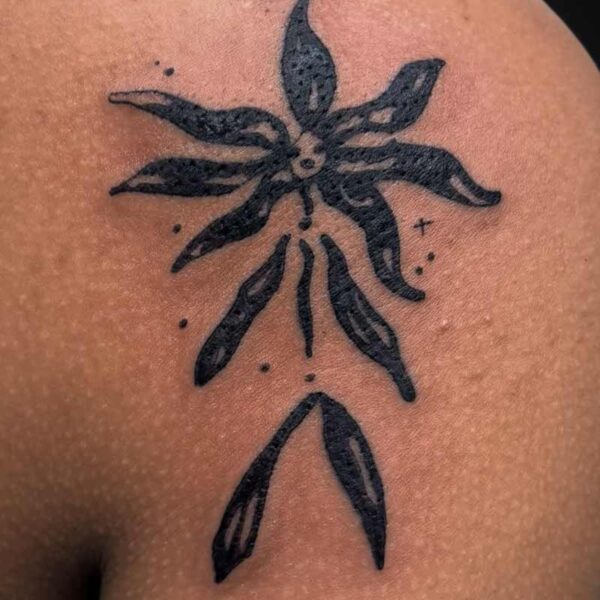 Blackwork Tattoo- Abstract Flower Atticus Tattoo| Blackwork tattoo of a stylized, abstract flower in the shape of a stick person
