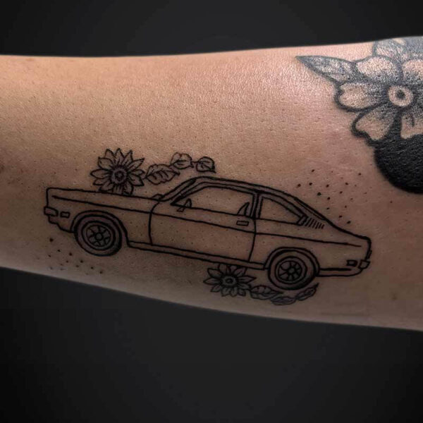 Blackwork Tattoo- Car and Flowers Atticus Tattoo| Blackwork tattoo of a car with flowers