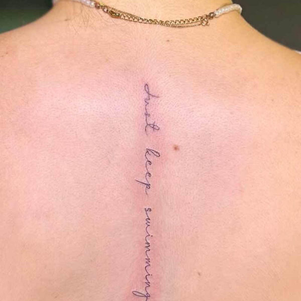 fineline-script-back-tattoo