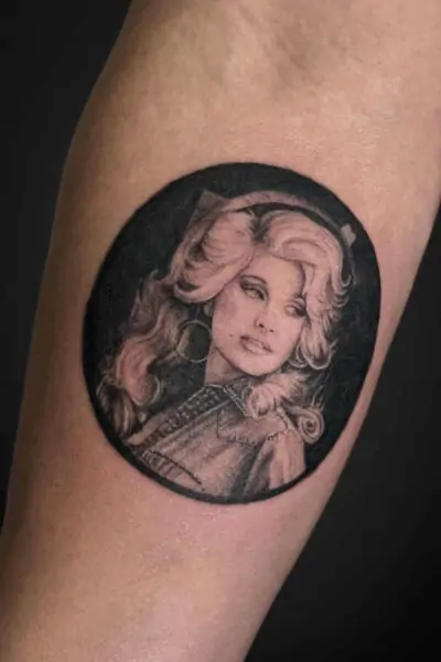 Atticus Tattoo| Black and grey realism tattoo of a portrait of Dolly Parton
