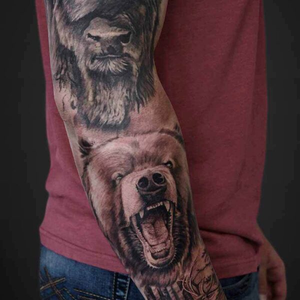 Black and Grey Realism Tattoo- Nature Sleeve Atticus Tattoo| Black and grey realism tattoo of a bison, grizzly bear and elk
