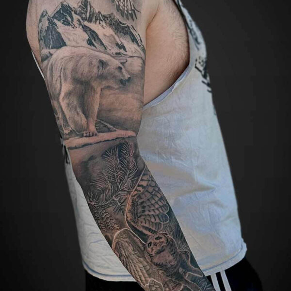 Black and Grey Realism Tattoo- Nature Sleeve Atticus Tattoo| Black and grey realism tattoo of a falcon, polar bear and a great horned owl