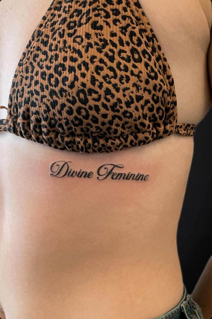 Atticus Tattoo| Feminine tattoo| Script tattoo| Tattoo of the words "Divine Feminine"