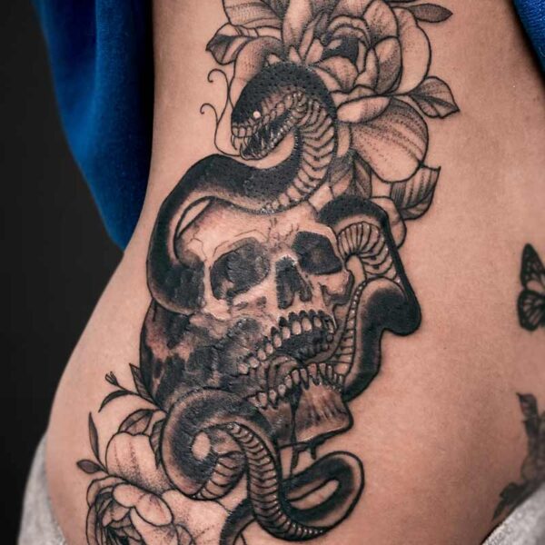 neotraditional-tattoo-snake-skull-flowers