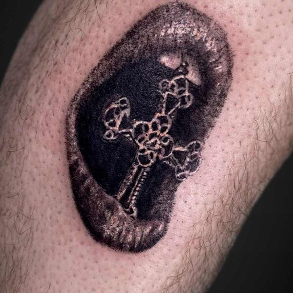 realism-tattoo-mouth-biting-cross