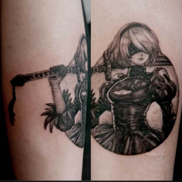 Tattoo of a female samurai in a black outfit, blindfolded, holding a long sword across her body in two-panel design.
