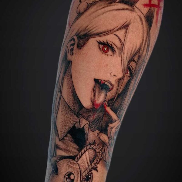 Tattoo of a pale-haired woman with red eyes sticking out her tongue, a cat perched on her head, and a cartoon creature at the lower forearm.