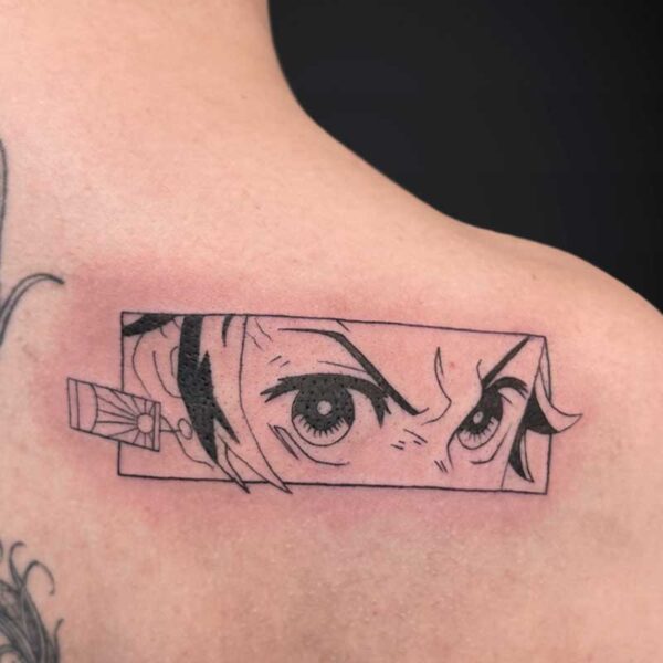 shoulder tattoo: rectangular manga-panel with intense eyes peering out, left edge shows a small rectangular connector